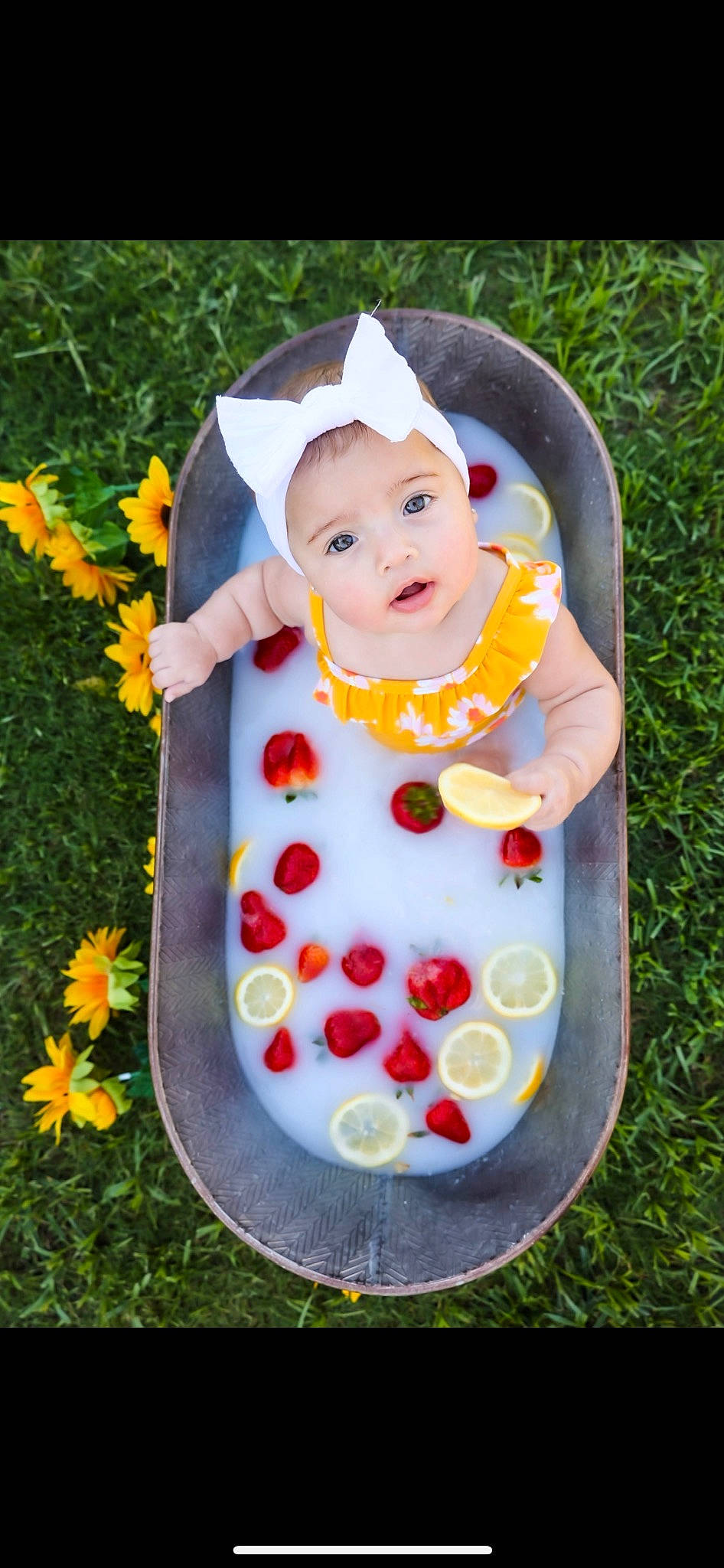 Teagan joined the competition — help win amazing prizes! annual_plant, art, baby, baby_products, baby_toddler_clothing, botany, child, flower, flowering_plant, garden, grass, happy, hat, headwear, pattern, people_in_nature, person, petal, plant, sitting