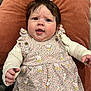Joy joined the competition — help win amazing prizes! baby, bodypart, clothing, couch, cushion, dress, face, finger, frown, furniture, hand, head, homedecor, newborn, person, photography, pillow, portrait, quilt, sad