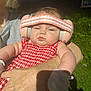 Ellie is registered to the contest to win money with this photo: baby, child, earmuffs, red_dress, checkered_pattern, adult_arm, outdoor, night, greenery, mittens, sleepy, person, holding, skin, shadow, headwear, cute, infant, young_child, portrait