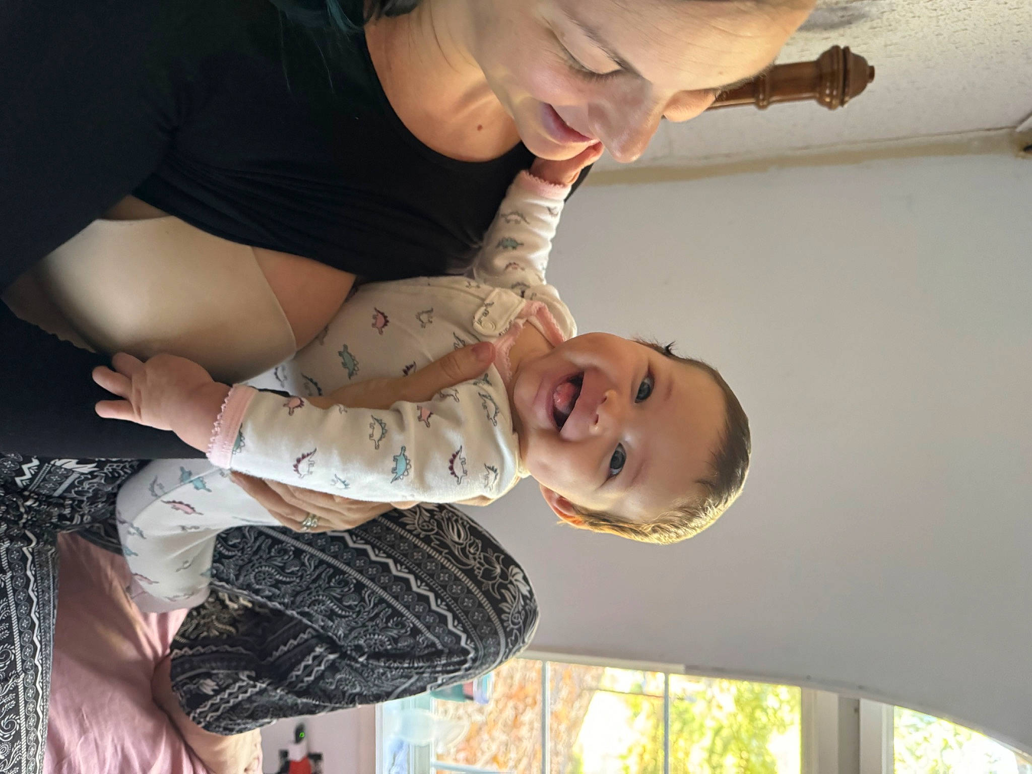 Lara is registered to the contest to win money with this photo: abdomen, chest, child, clothing, elbow, fun, gesture, happy, joint, joy, laugh, pattern, person, room, smile, toddler, tree, trunk, white, window