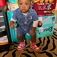 Keyunna joined the competition — help win amazing prizes! toddler, child, denim, romper, pink_sneakers, carpet, zebra_pattern, snack_boxes, household_items, indoor, curious, standing, clothing, face, person, floor, socks, hair, room, photography