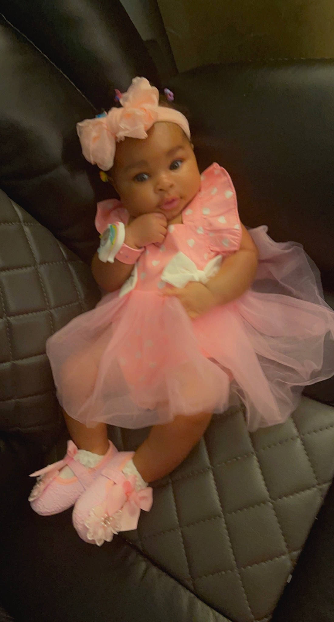 Daniella is registered to the contest to win money with this photo: baby, baby_toddler_clothing, bridal_accessory, child, comfort, costume, day_dress, dress, embellishment, fashion_accessory, foot, headwear, human_body, nail, peach, person, pink, ruffle, sitting, skin