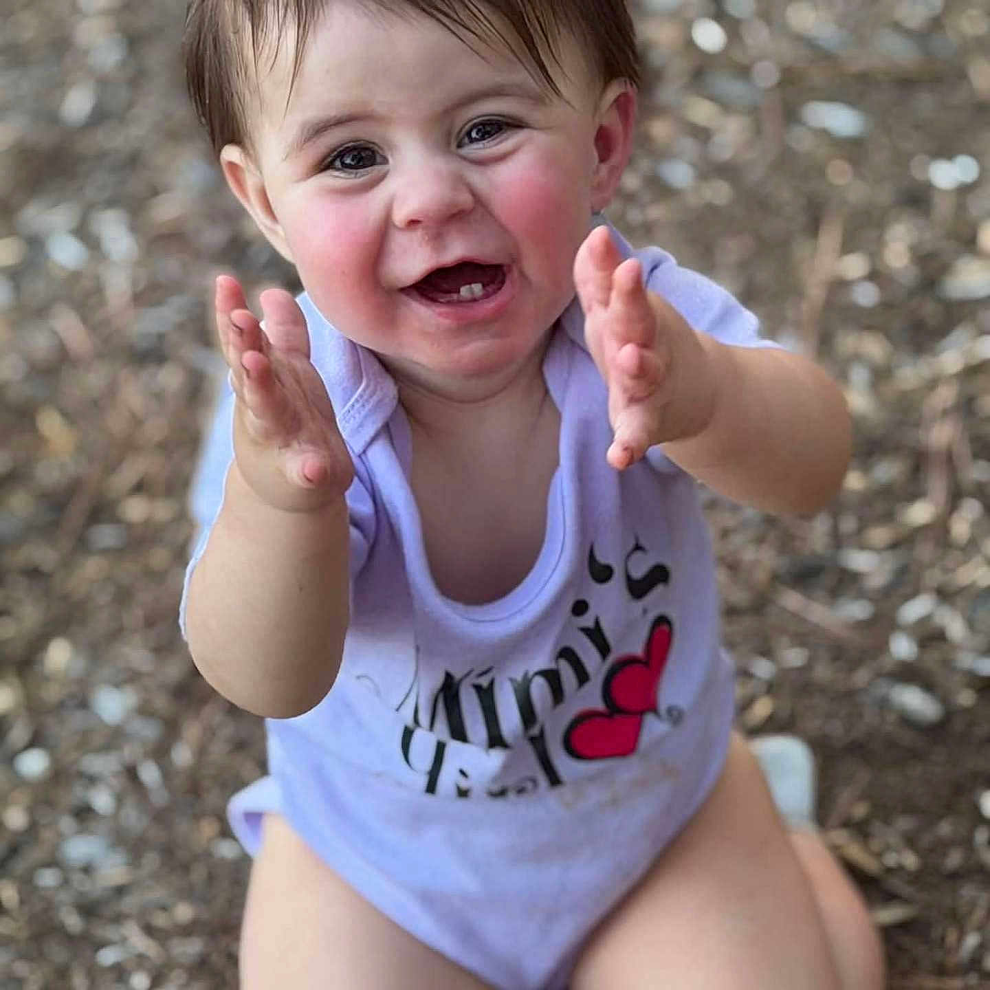 Violet is registered to the contest to win money with this photo: baby, child, clapping, smiling, happy, outdoor, portrait, face, eyes, hands, sitting, infant, toddler, purple_clothing, minnie_mouse, cartoon, woodland, leaves, bokeh, photography