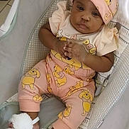 Mahlani is registered to the contest to win money with this photo: baby, infant, child, pink_clothing, hat, slippers, baby_chair, cushion, floor_tiles, person, hand, cute, indoors, portrait, expression, footwear, toddler, resting, comfortable, young_child