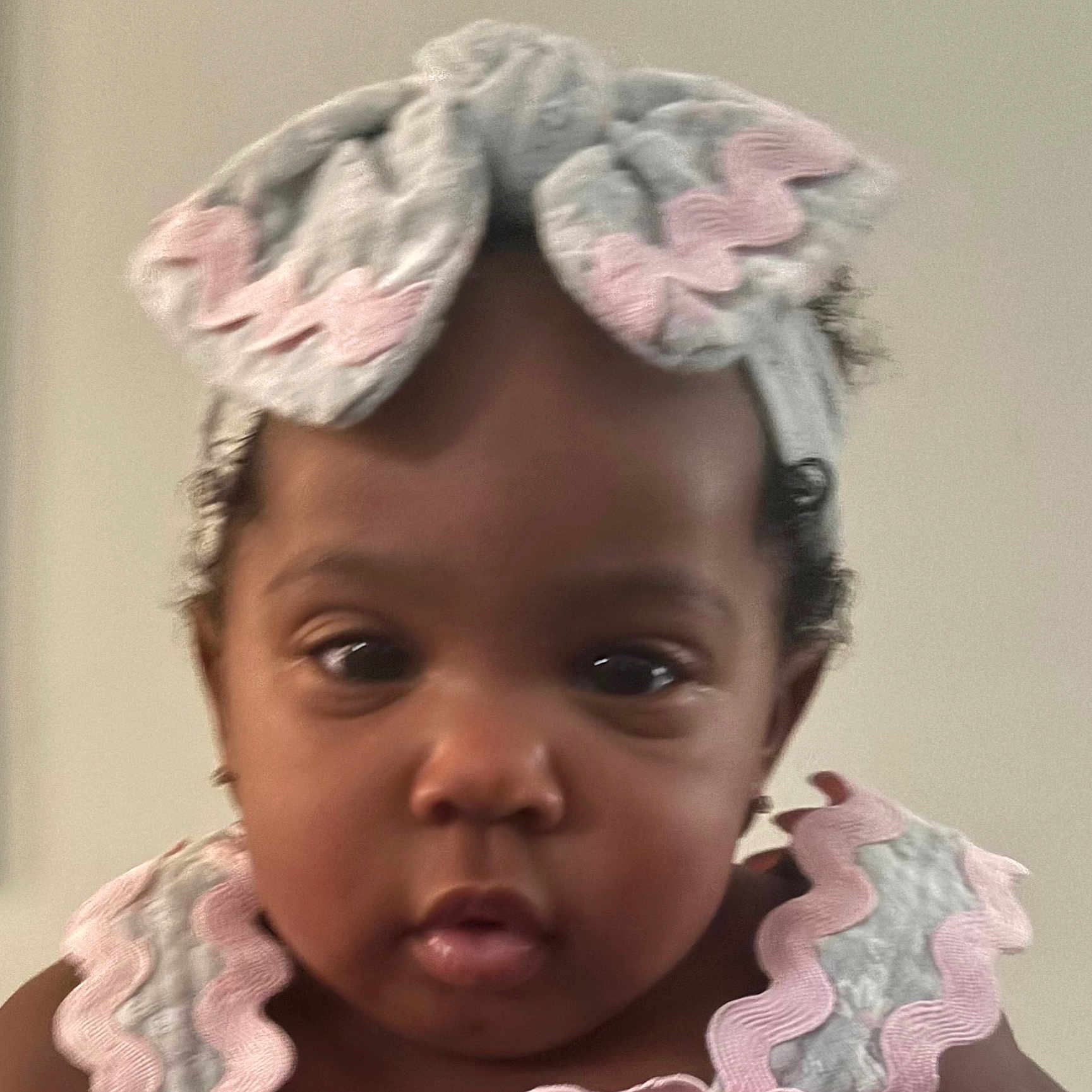 Mahlani is registered to the contest to win money with this photo: baby, child, face, headband, clothing, pink, pastel_colors, portrait, closeup, curly_hair, infant, cute, expression, indoors, person, young_child, headwear, fashion, adorable, skin