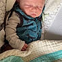 baby, sleeping, blanket, vest, animal_print, baby_seat, cozy, infant, child, peaceful, soft_texture, cushion, clothing, nap, indoor, portrait, cute, resting, newborn, comfort