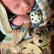 Caleb joined the competition — help win amazing prizes! baby, sleeping, blanket, knitted, pacifier, crocheted_toy, teddy_bear, milestone_card, one_month, infant, cute, soft, wrapped, closeup, face, hand, fabric, pattern, resting, newborn