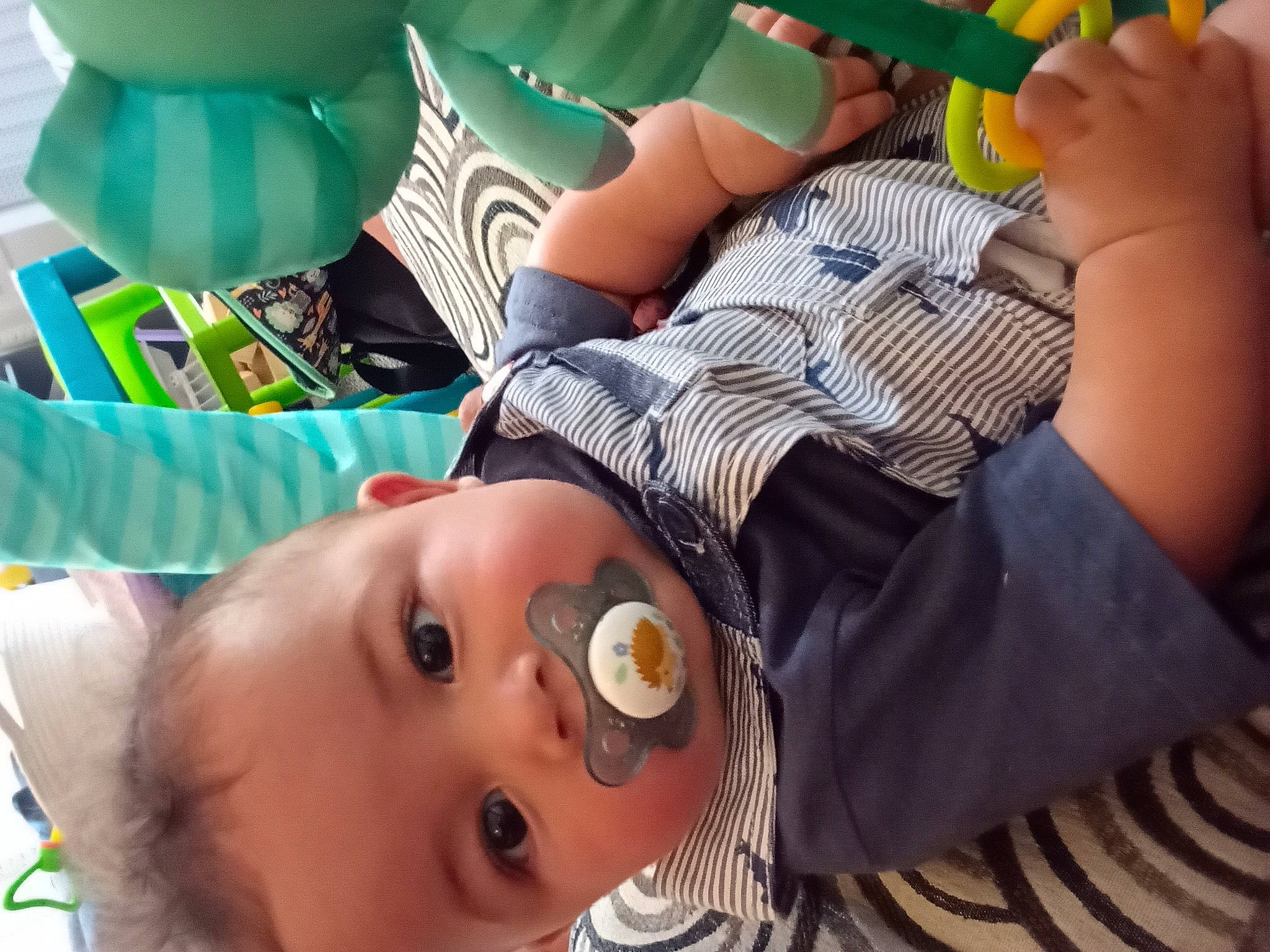 Cassius is registered to the contest to win money with this photo: baby, baby_toddler_clothing, balloon, chair, child, finger, fun, green, happy, hat, leisure, mouth, nail, orange, person, product, skin, summer, tableware, thigh