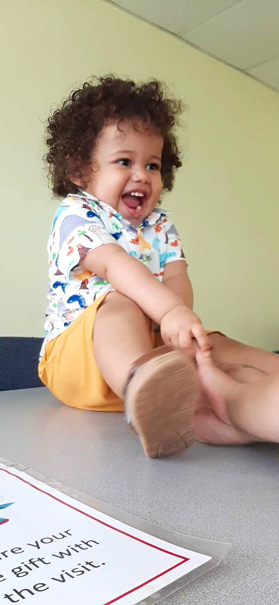 Cyrus is registered to the contest to win money with this photo: arm, baby_toddler_clothing, cheek, elbow, face, finger, flash_photography, gesture, happy, human_body, joint, knee, person, shorts, shoulder, skin, sleeve, smile, stomach, thigh
