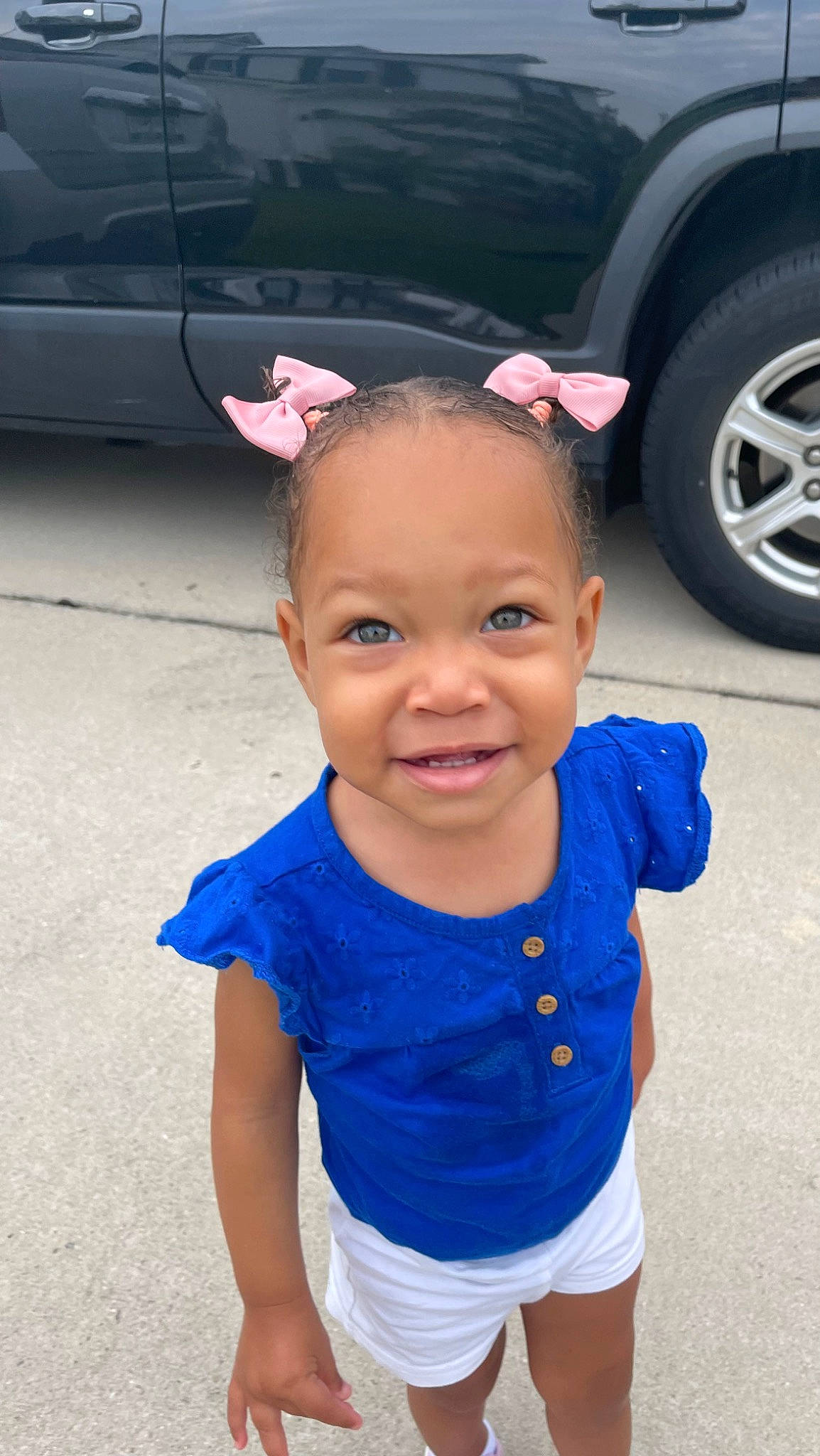 Arianna Harper is registered to the contest to win money with this photo: asphalt, automotive_design, automotive_lighting, automotive_tire, baby_toddler_clothing, car, cool, happy, mammal, motor_vehicle, person, pink, public_space, skin, sleeve, smile, tire, toddler, vehicle_door, wheel