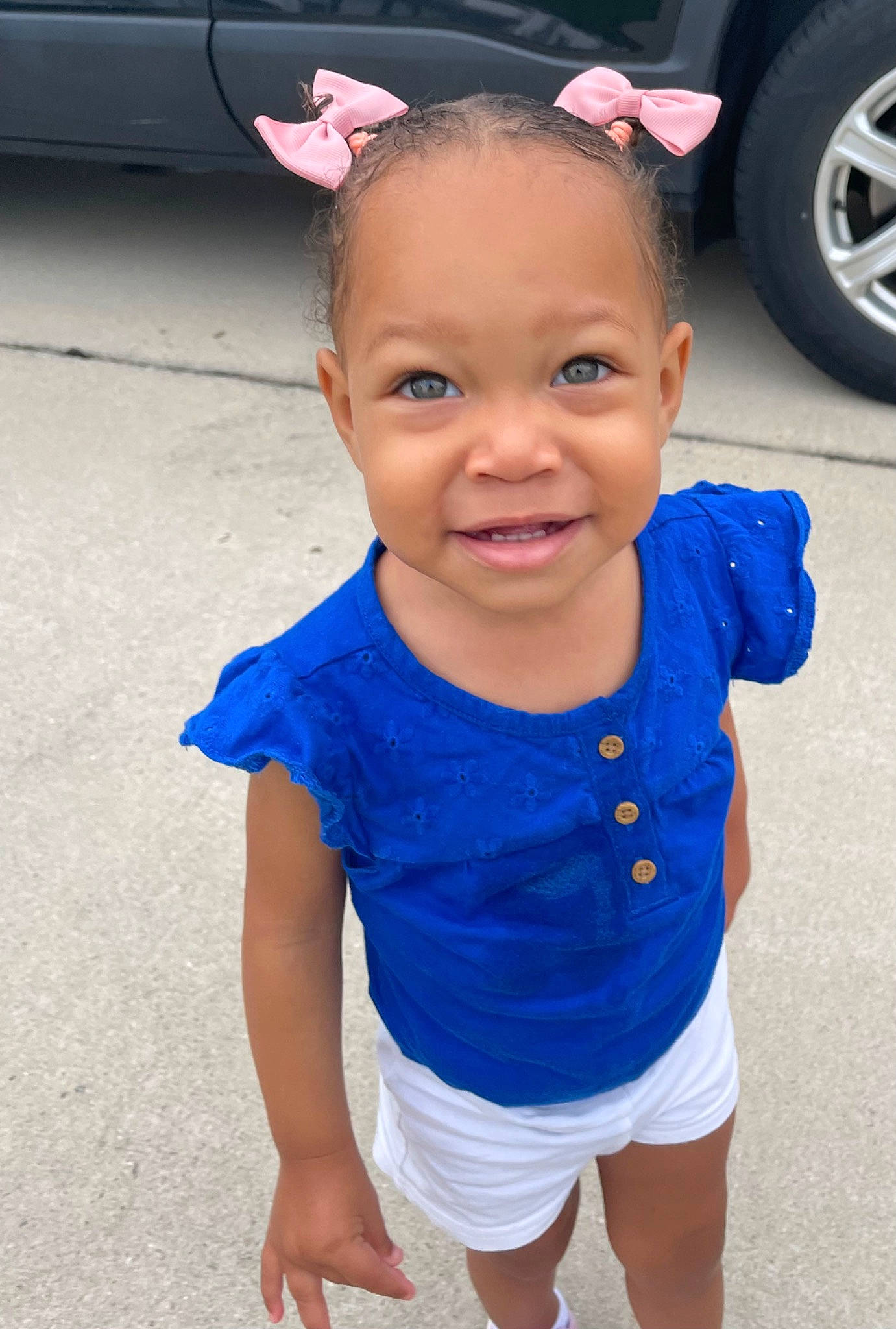 Arianna Harper is registered to the contest to win money with this photo: automotive_tire, azure, baby_toddler_clothing, blue, child, cool, electric_blue, face, hair, happy, head, headgear, person, pink, sleeve, smile, tire, toddler, vehicle_door, wheel