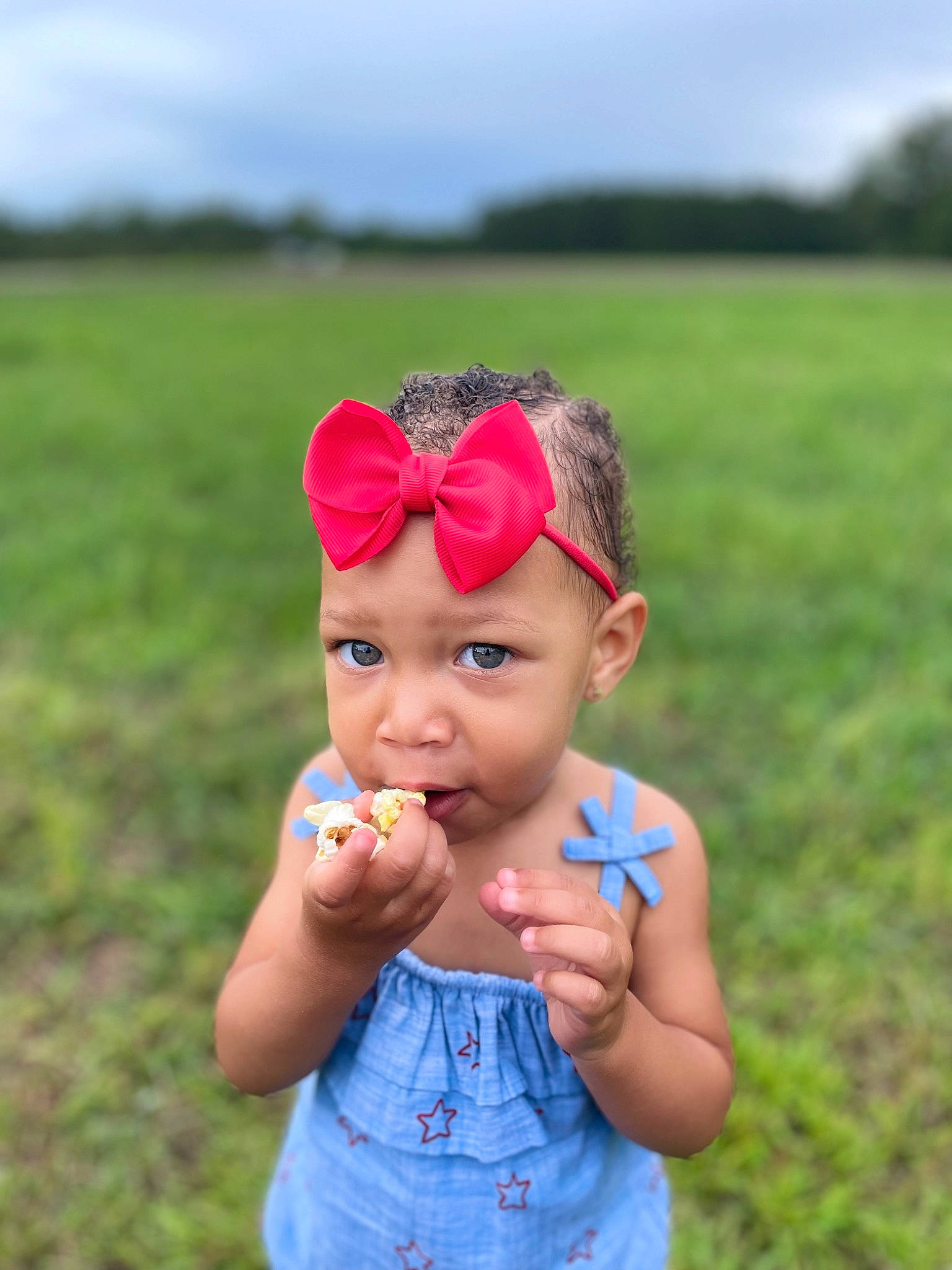 Arianna Harper is registered to the contest to win money with this photo: baby, baby_toddler_clothing, blue, fun, gesture, grass, grass_family, grassland, happy, headband, headpiece, headwear, magenta, meadow, people_in_nature, person, plant, prairie, sky, summer