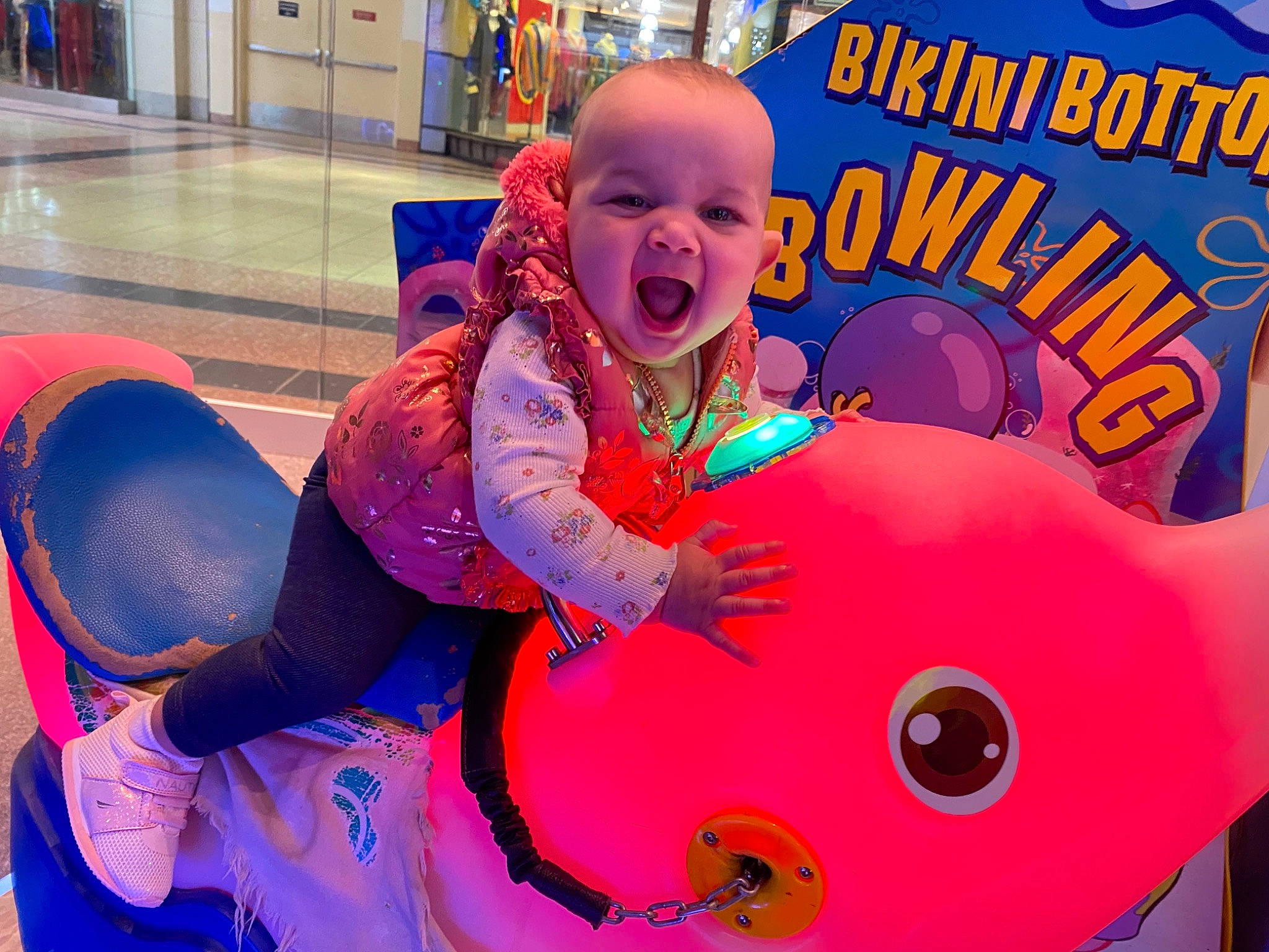 Avni is registered to the contest to win money with this photo: baby, child, event, facial_expression, fun, happy, inflatable, leisure, magenta, mammal, organ, party_supply, person, personal_protective_equipment, pink, play, playground, purple, recreation, smile