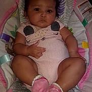 Serenity is registered to the contest to win money with this photo: baby, infant, child, portrait, lying_down, sitting, wide_eyed, neutral_expression, pink_outfit, onesie, socks, play_mat, baby_gym, toy, indoor, close_up, face, arms, legs, colorful_background