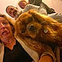 dog, brown_dog, person, woman, man, glasses, funny_face, indoor, casual, selfie, tongue_out, long_ears, smile, group, portrait, candid, beard, sweater, jacket, happy