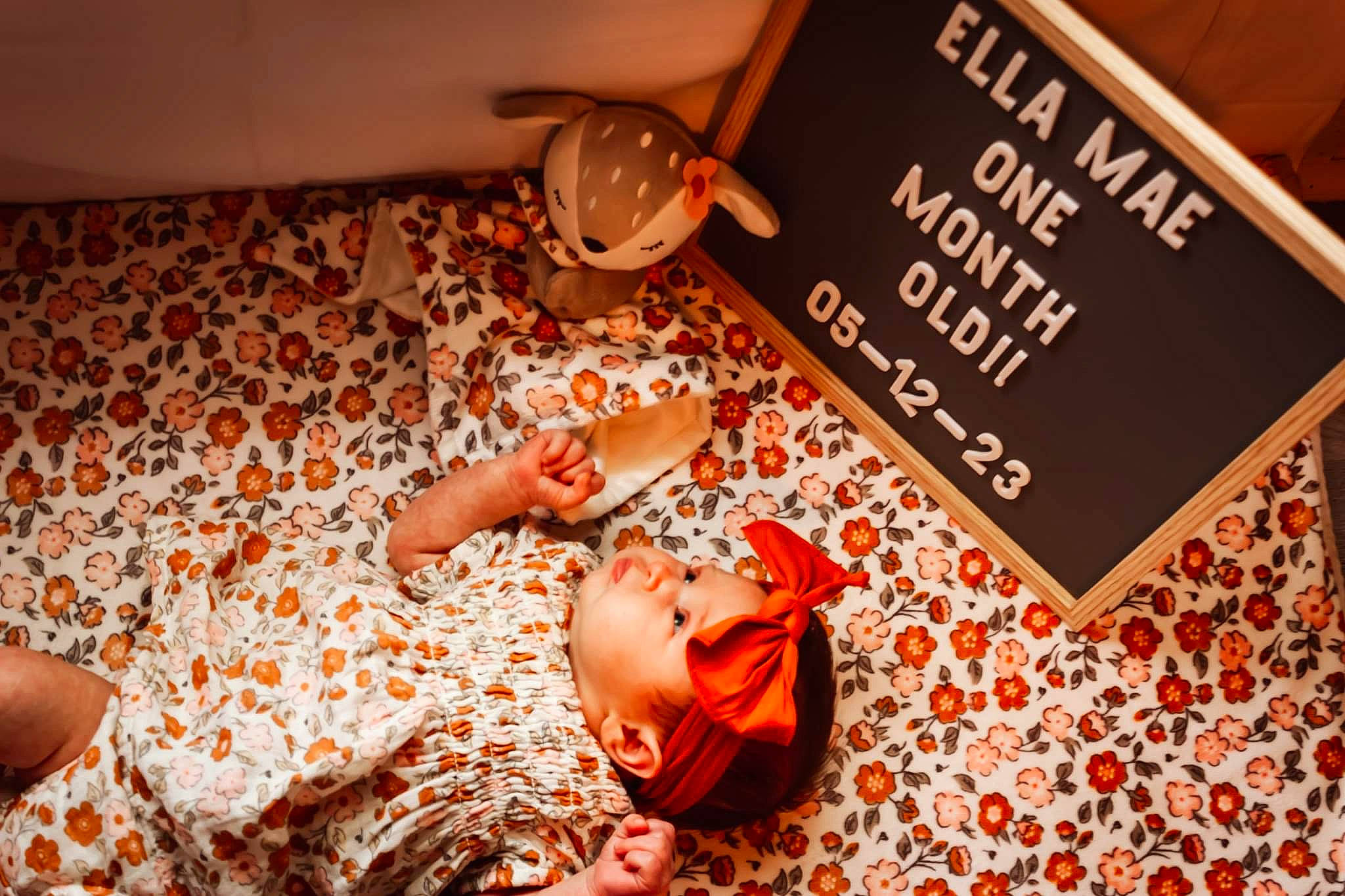 Ella Mae is registered to the contest to win money with this photo: baby, brown, child, comfort, event, flesh, flooring, font, fun, human_leg, linens, nail, orange, pattern, peach, person, room, toddler, wood