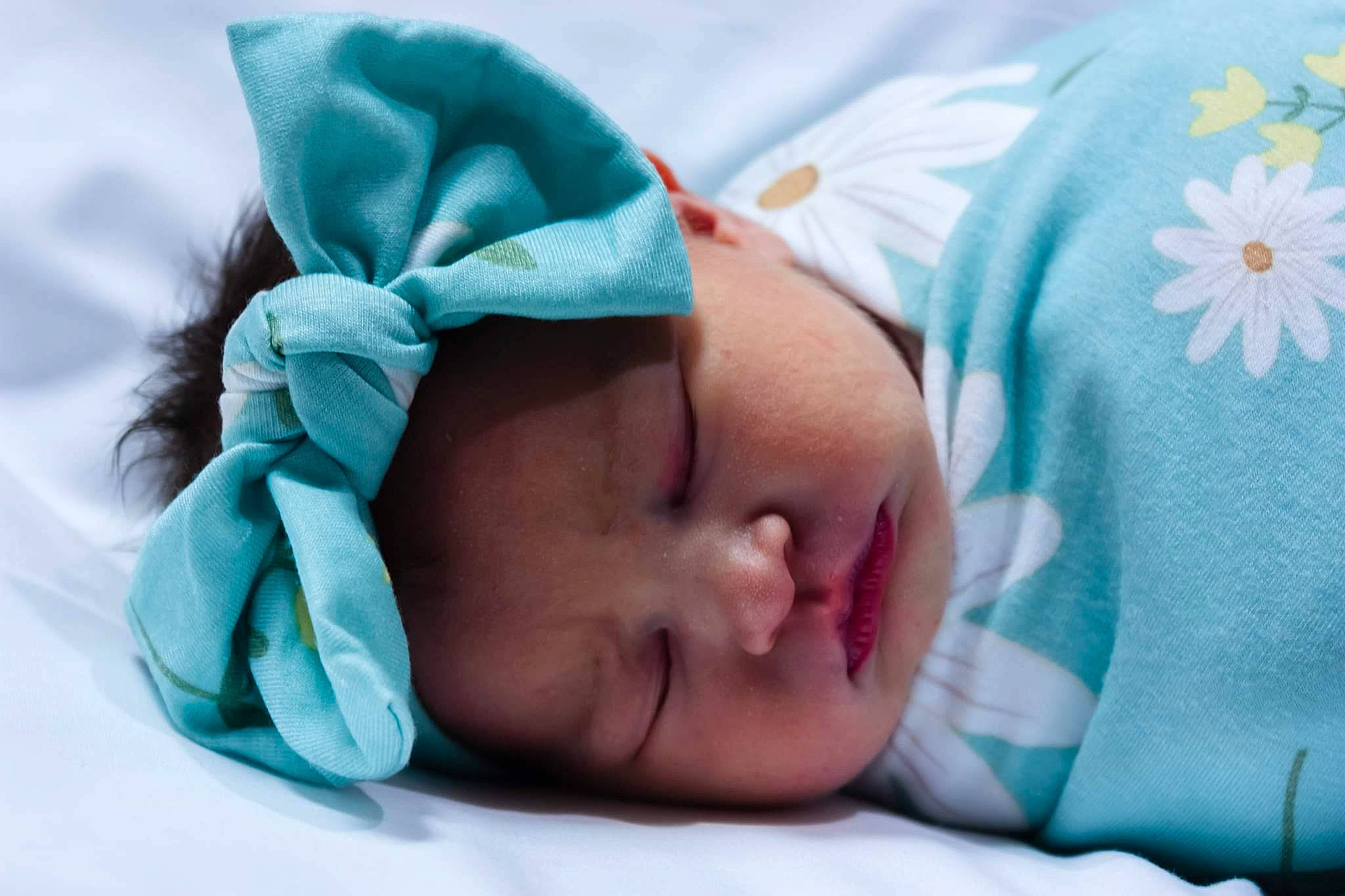 Ella Mae is registered to the contest to win money with this photo: baby, baby_products, baby_sleeping, baby_toddler_clothing, bedtime, cheek, child, comfort, eyelash, fashion_accessory, flower, grass, headwear, iris, linens, nap, pattern, person, portrait_photography, skin