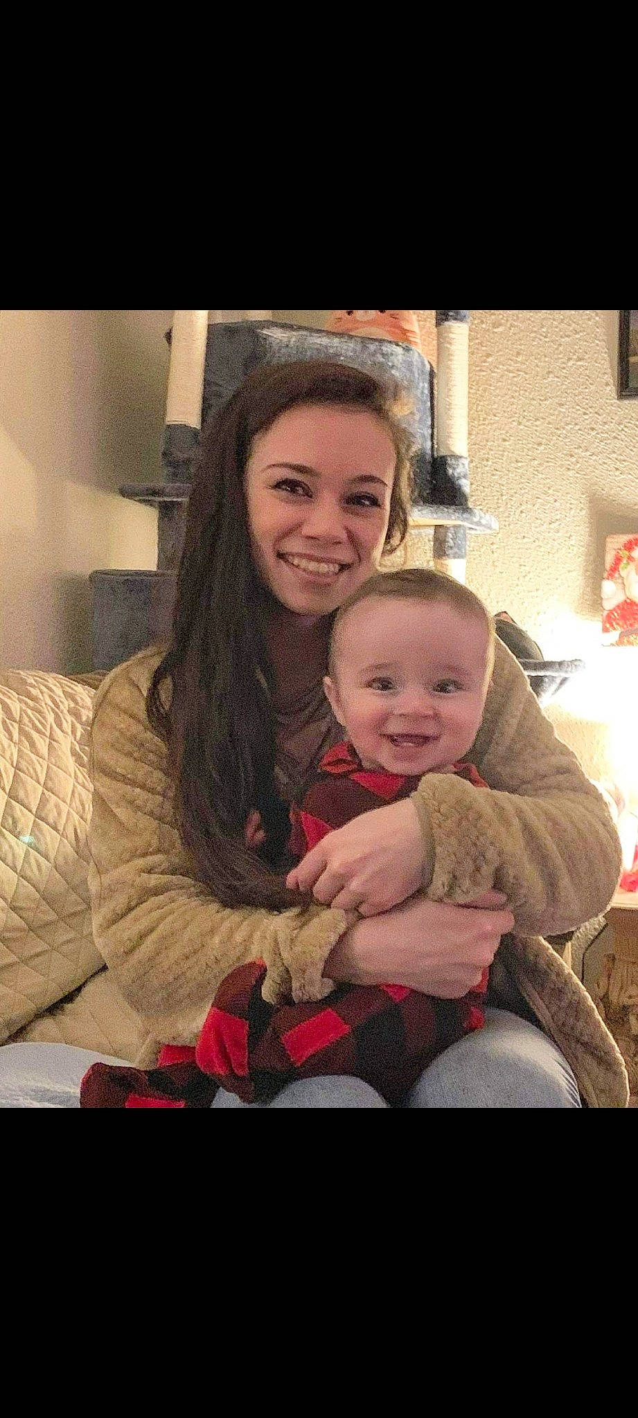 Forest is registered to the contest to win money with this photo: baby, cheek, child, christmas, comfort, couch, event, flash_photography, fun, gesture, hair, happy, iris, joy, lap, laugh, living_room, person, room, sitting