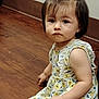 Makenzie is registered to the contest to win money with this photo: toddler, child, girl, dress, floral, yellow, ruffles, sitting, wooden_floor, indoor, person, cute, serious_expression, short_hair, portrait, young_child, skin, face, hand, floor