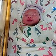 Makenzie is registered to the contest to win money with this photo: newborn, baby, infant, blanket, hospital, bassinet, hat, sleeping, footprints, swaddled, wrapped, bed, child, person, cute, small, headwear, resting, indoors, soft