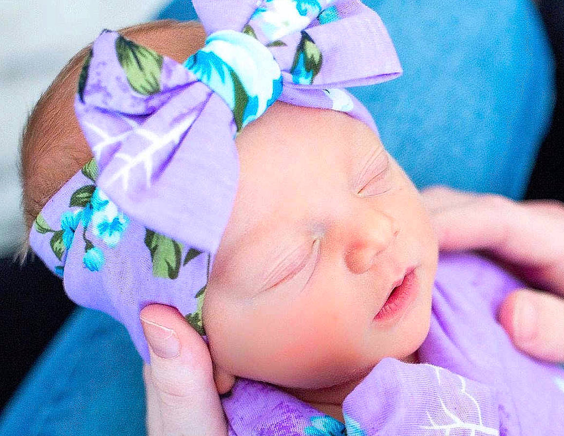 Mia is registered to the contest to win money with this photo: baby, blue, child, fashion_accessory, hair_accessory, hair_tie, hand, head, headband, headgear, headpiece, headwear, lavender, lilac, person, pink, product, purple, skin, toddler