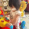 Anna Chin is registered to the contest to win money with this photo: toddler, child, toy, walker, indoor, playroom, colorful, bee_backpack, medical_patch, cute, floor_mat, furniture, rainbow, shelf, plastic_toy, red_sofa, baby_clothes, hands, feet, playtime