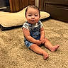 Kolter is registered to the contest to win money with this photo: toddler, child, carpet, denim_overalls, white_shirt, sitting, living_room, brown_couch, pet_bed, floor, indoors, cute, young_child, person, furniture, carpeted_floor, short_hair, skin, feet, casual_clothing