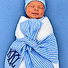 Kason joined the competition — help win amazing prizes! newborn, baby, infant, sleeping, swaddled, blanket, blue, white, striped, hat, cap, portrait, close_up, peaceful, face, indoors, textile, cozy, resting, photography