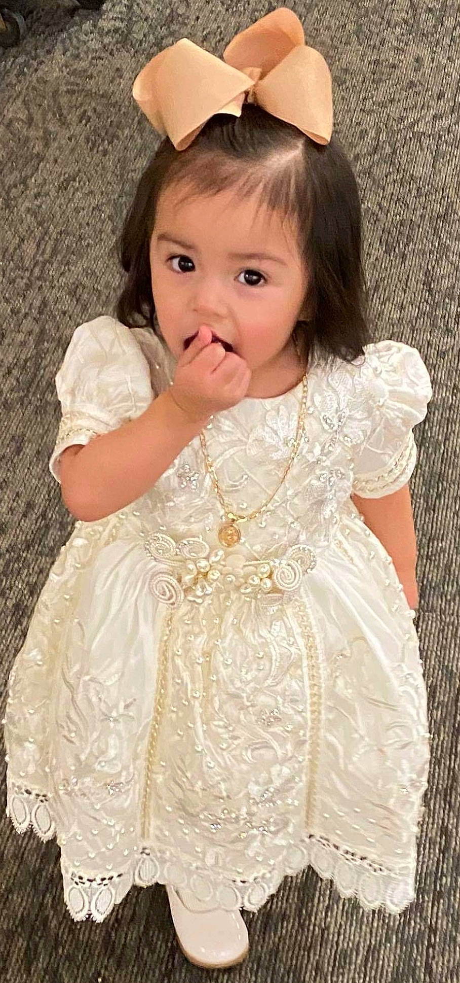 Luna is registered to the contest to win money with this photo: baby, brown_hair, cheek, child, child_model, clothing, dress, gown, hairstyle, lace, long_hair, person, skin, smile, toddler