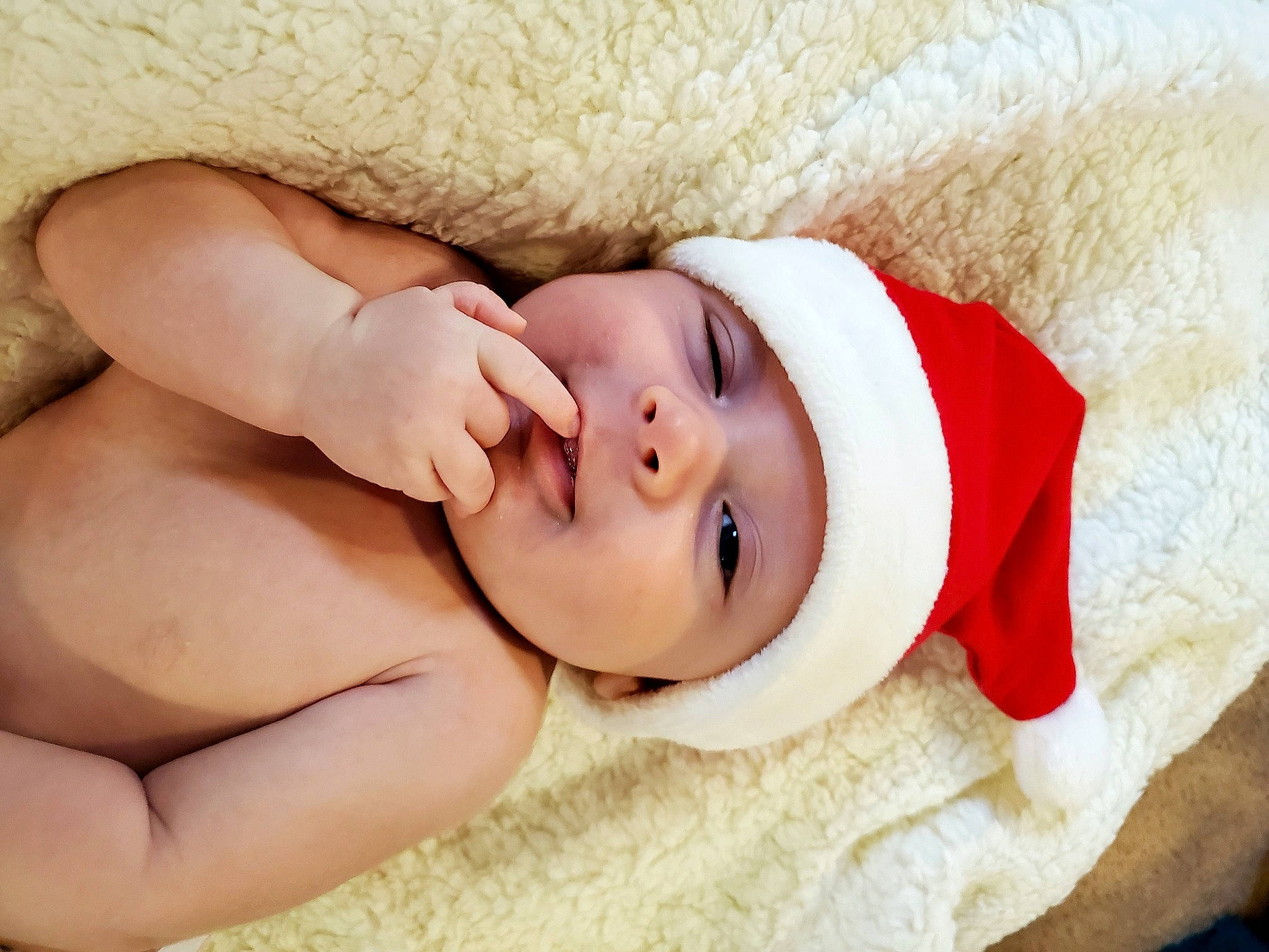 Gideon is registered to the contest to win money with this photo: arm, baby, baby_sleeping, baby_toddler_clothing, child, comfort, eye, fur, hand, happy, hat, head, headgear, headwear, human_body, linens, lip, person, portrait_photography, skin