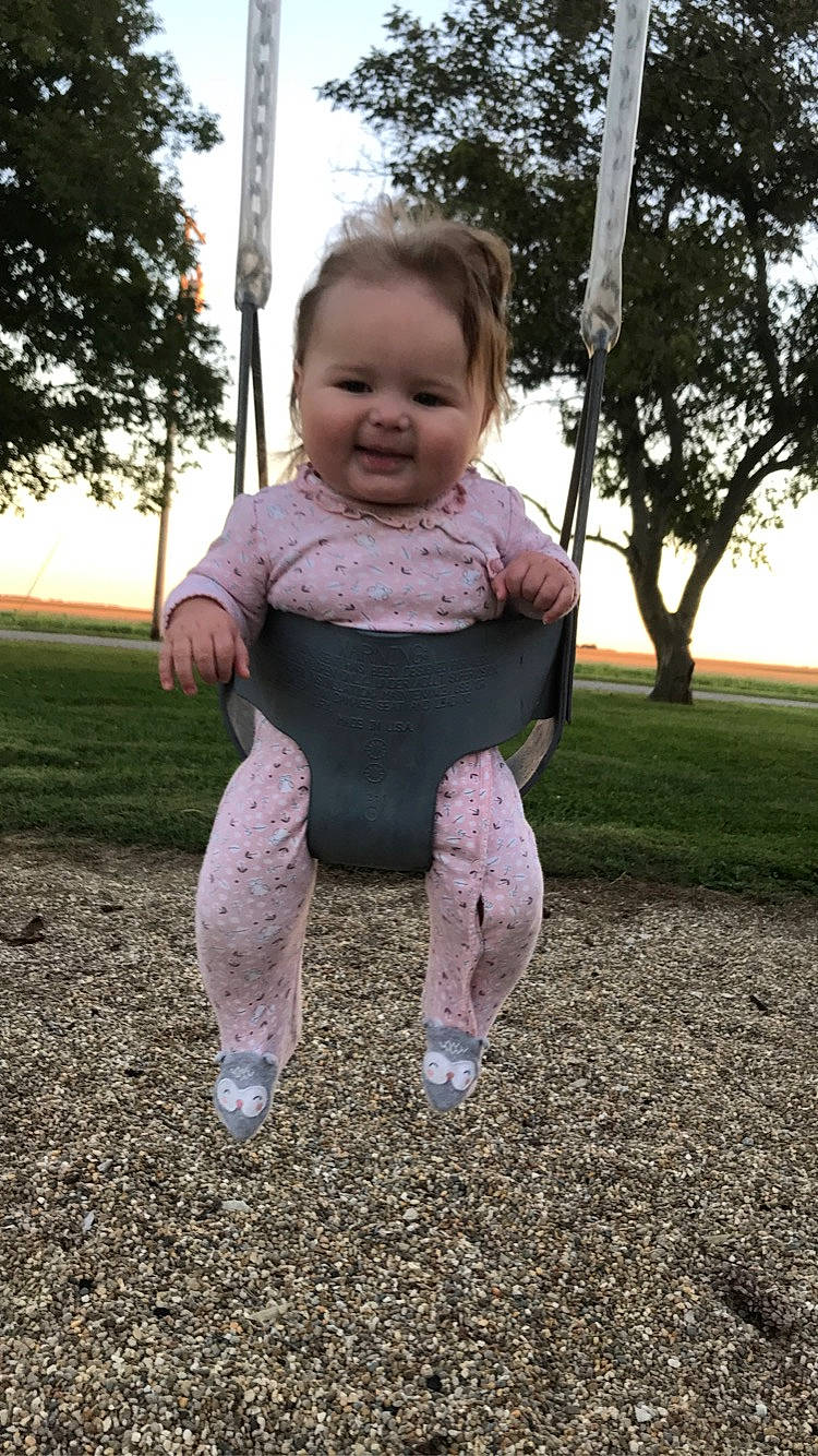 Vivienne is registered to the contest to win money with this photo: baby, baby_toddler_clothing, eye, face, finger, fun, gesture, grass, happy, leisure, people_in_nature, person, plant, playground, recreation, sky, sleeve, smile, t_shirt, toddler