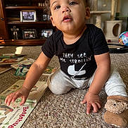 Kimoni joined the competition — help win amazing prizes! toddler, child, crawling, carpet, book, reading, indoor, living_room, black_shirt, slippers, bear_slippers, curly_hair, face, expression, toy, cat_tree, furniture, floor, person, home