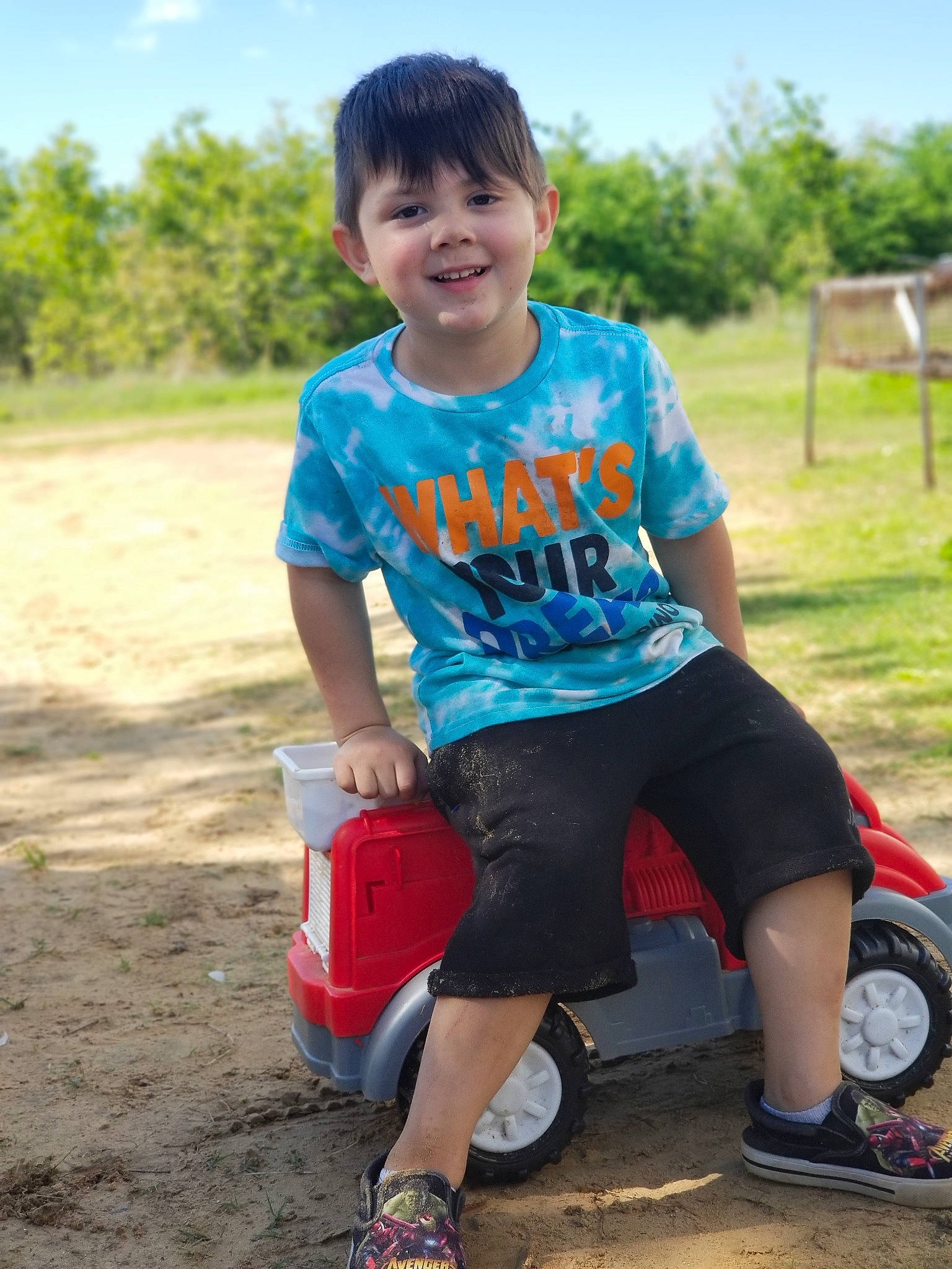 Blayne joined the competition — help win amazing prizes! adaptation, child, fun, happy, joy, male, person, play, playground, recreation, sitting, smile, soil, summer, t_shirt, toddler, vehicle