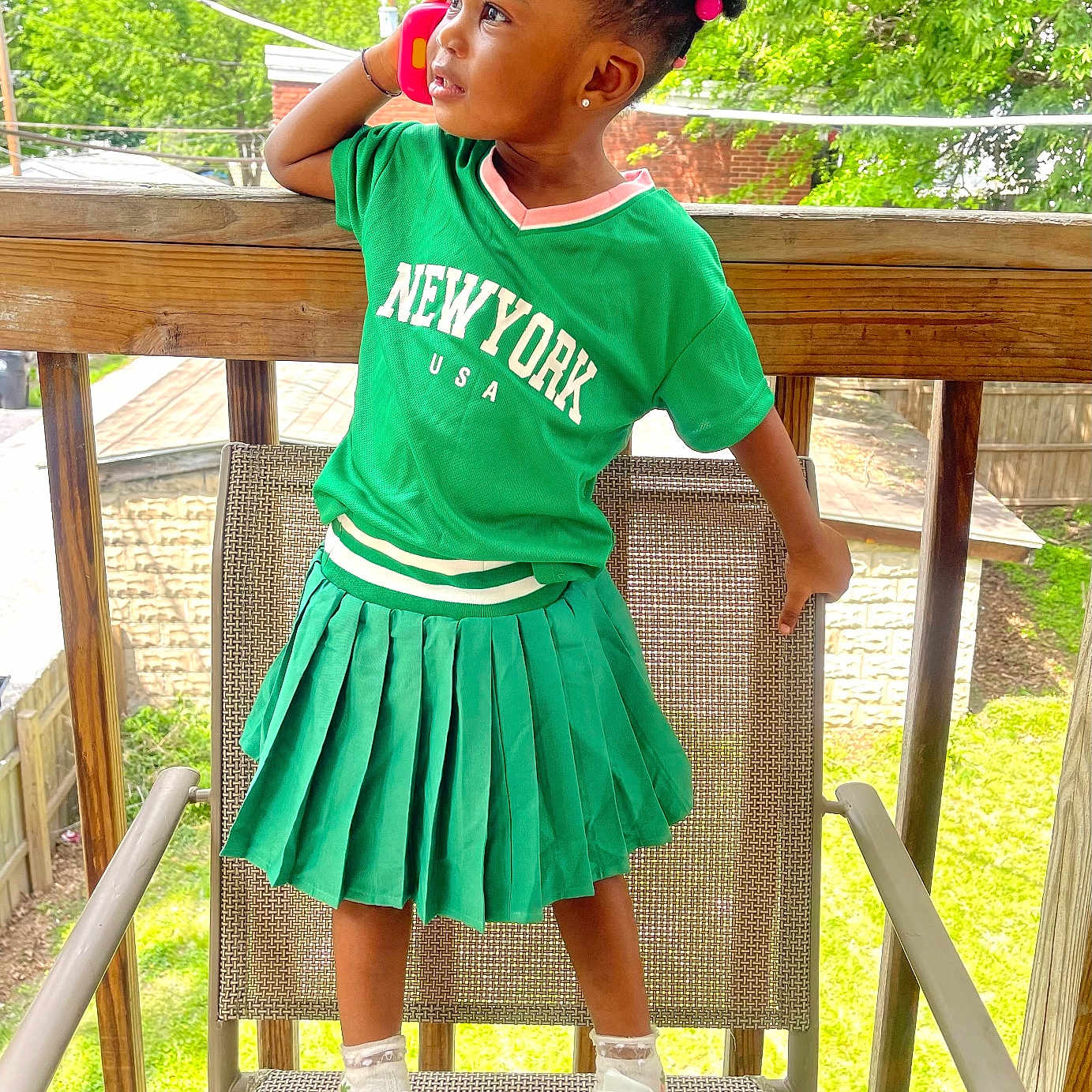 Hasina joined the competition — help win amazing prizes! architecture, building, child, clothing, dress, face, female, footwear, girl, head, house, housing, person, photography, porch, portrait, shoe, skirt, t_shirt, wood