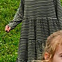 background, blonde_hair, blue_chair, casual_clothing, child, daylight, folding_chair, fun, girl, grass, greenery, happy, nature, outdoor, person, playful, portrait, smile, striped_dress, two_children