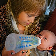 Sophia joined the competition — help win amazing prizes! baby, blanket, bond, bottle, child, closeup, clothing, comfort, cute, expression, face, family, feeding, hair, hand, indoor, love, nurturing, person, warmth