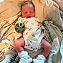 Van is registered to the contest to win money with this photo: baby, blanket, booties, clothing, cozy, cute, face, human, indoors, infant, legs, lying_down, newborn, onesie, peaceful, rest, skin, sleeping, soft, toy