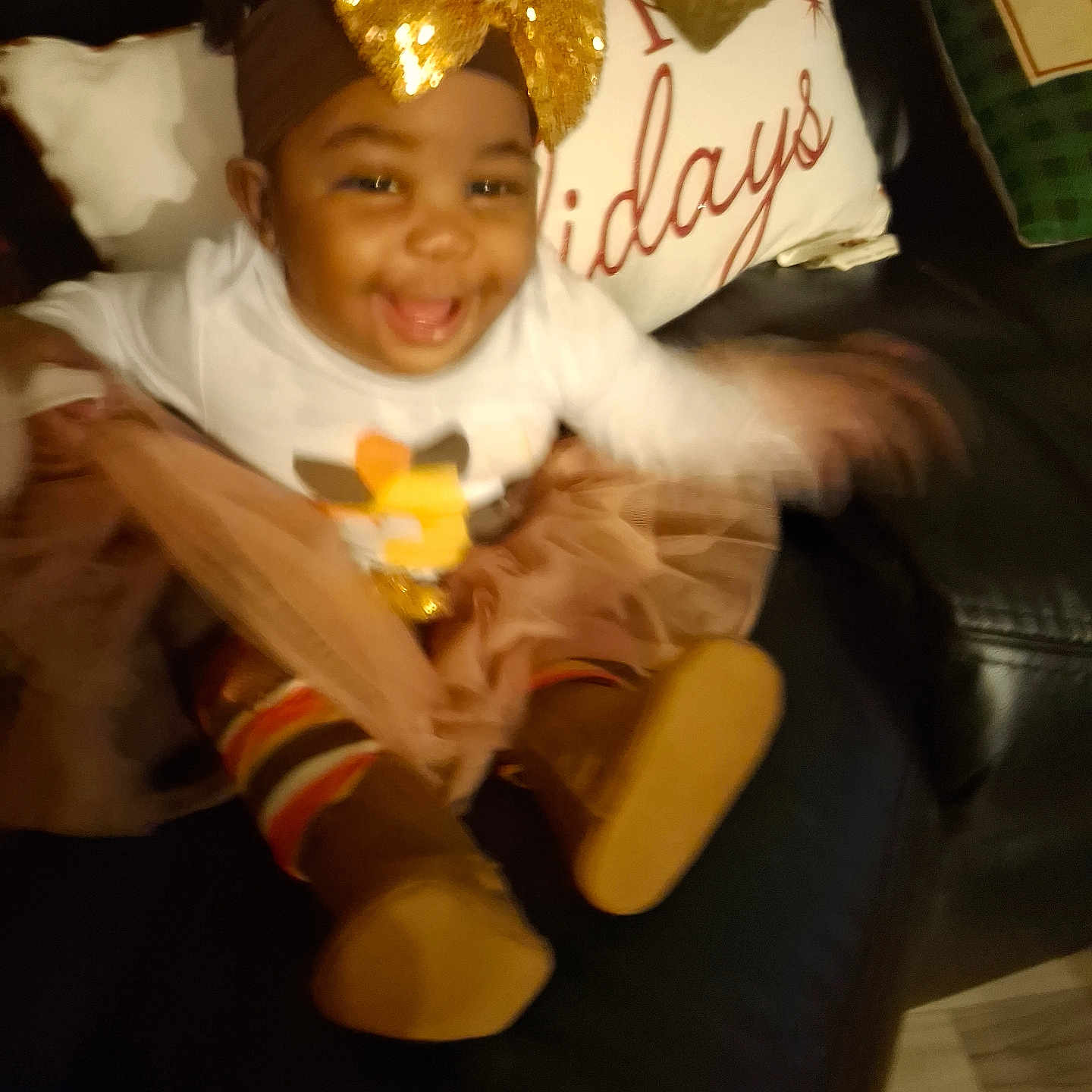 Hazel Willis joined the competition — help win amazing prizes! baby, boots, celebration, child, clothing, couch, cute, golden_bow, happy, headband, holiday_theme, indoor, infant, joyful, motion_blur, person, pillow, smiling, striped_leggings, tutu