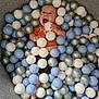 Sonny is registered to the contest to win money with this photo: baby, infant, smiling, happy, plastic_balls, ball_pit, blue, white, silver, clothing, orange_shirt, black_shorts, barefoot, indoor, playful, child, toy, fun, portrait, person