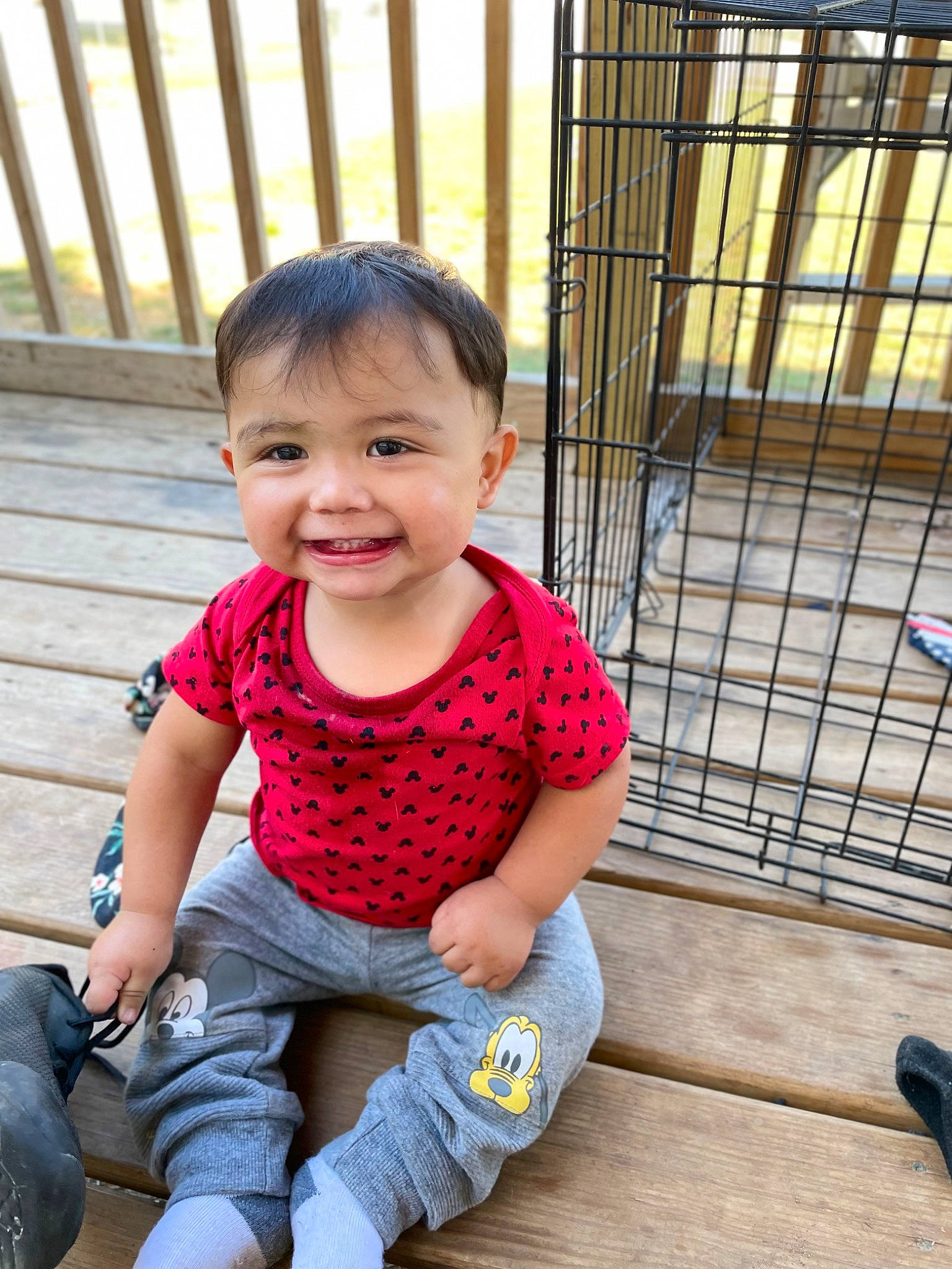 Aurelio is registered to the contest to win money with this photo: animal_shelter, baby, baby_toddler_clothing, cage, cheek, child, denim, grass, happy, joy, leisure, pattern, person, pet_supply, sitting, skin, sleeve, smile, t_shirt, toddler