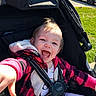 Astella is registered to the contest to win money with this photo: baby, black, child, cute, grass, happy, infant, jacket, joy, outdoor, parked_car, person, plaid, red, seatbelt, smile, stroller, sunlight, van, vehicle
