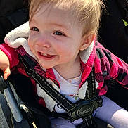 Astella joined the competition — help win amazing prizes! baby, black, blonde_hair, casual, child, clothing, daylight, face, happy, jacket, outdoor, person, pink, portrait, seat, smiling, straps, stroller, sunlight, toddler