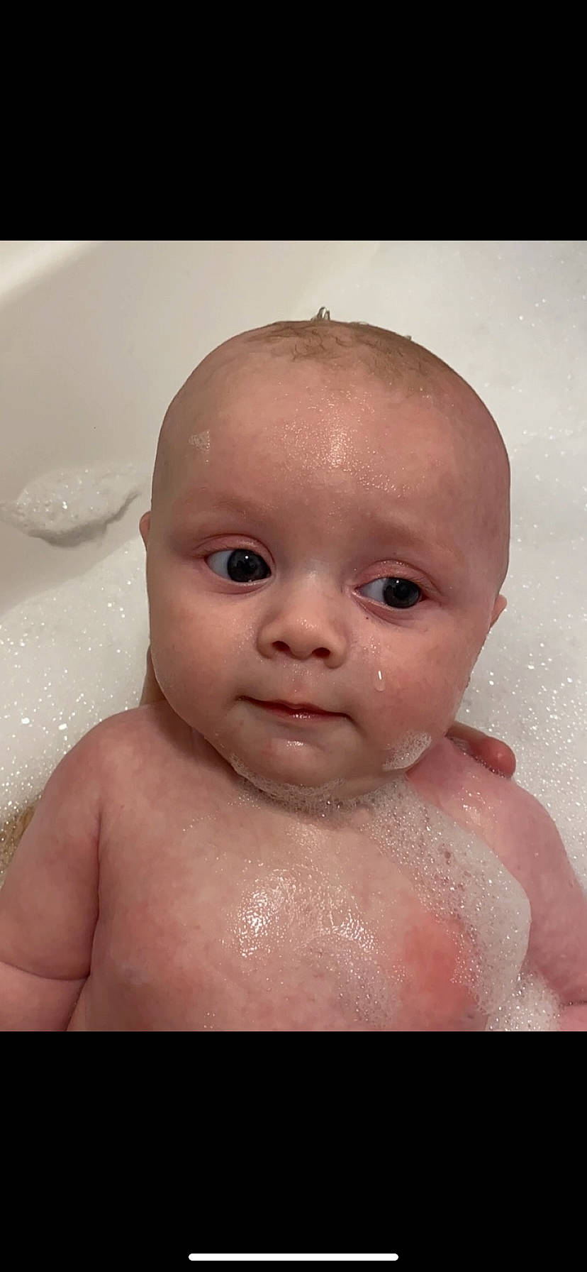 Harlan is registered to the contest to win money with this photo: baby_bathing, bathing, bathroom, bathtub, cheek, chest, ear, eye, eyelash, fluid, foam, human_body, iris, jaw, lip, liquid, mouth, neck, nose, person