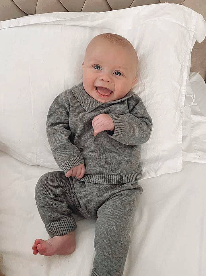 Harlan joined the competition — help win amazing prizes! arm, baby, baby_toddler_clothing, cheek, comfort, eye, face, grey, happy, head, iris, linens, nose, person, sitting, skin, sleeve, smile, t_shirt, textile
