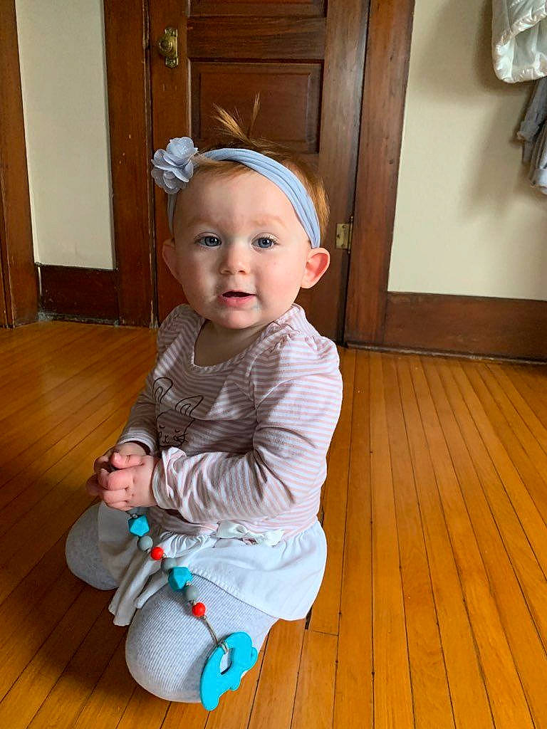Matilda is registered to the contest to win money with this photo: baby, baby_toddler_clothing, child, floor, flooring, hardwood, person, sitting, toddler, wood, wood_flooring