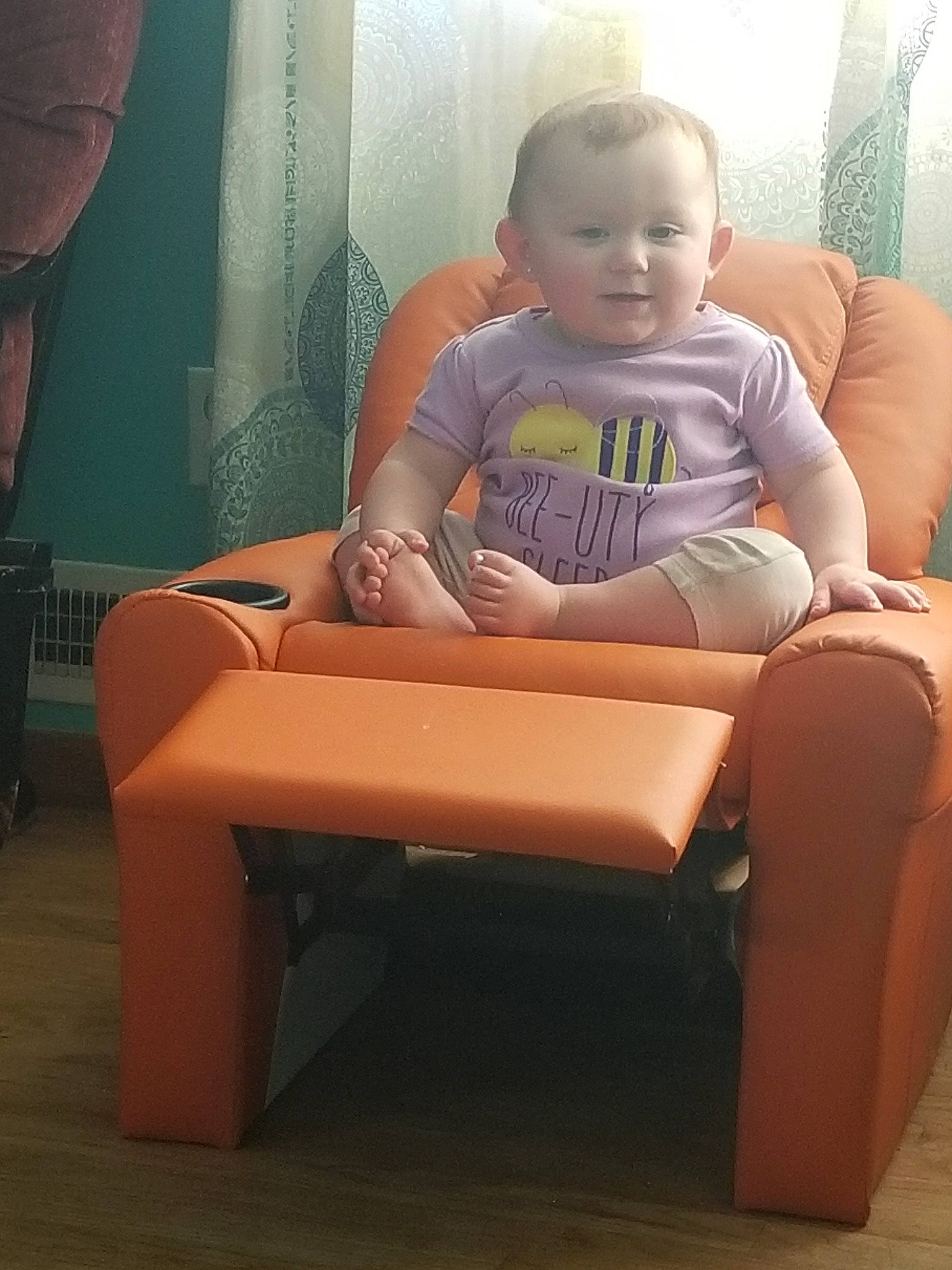 Matilda is registered to the contest to win money with this photo: baby, chair, child, comfort, couch, fun, furniture, leg, person, play, sitting, toddler, vacation