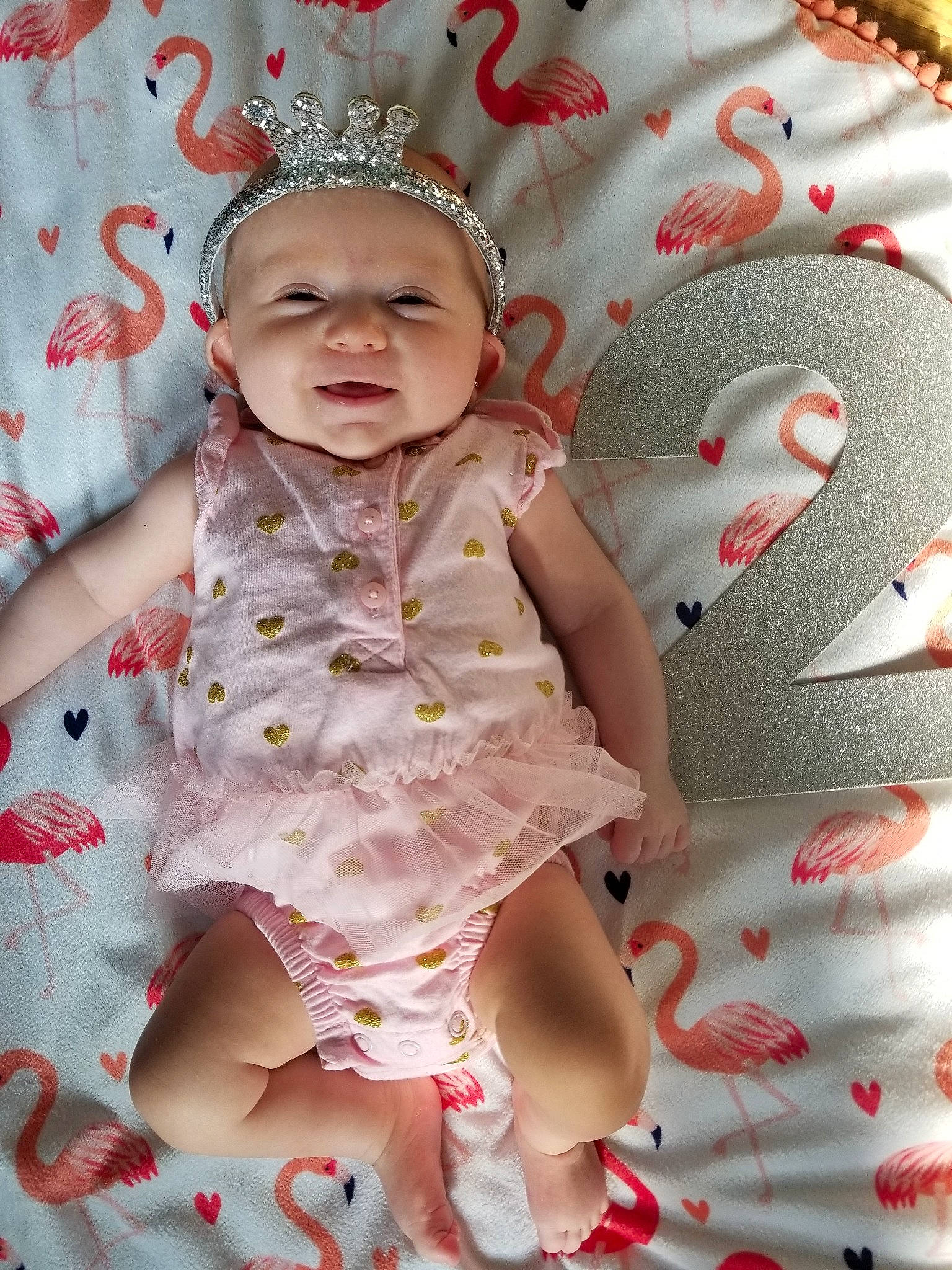 Matilda is registered to the contest to win money with this photo: baby, baby_toddler_clothing, cheek, child, doll, dress, hair_accessory, headwear, pattern, person, pink, play, skin, smile, textile, toddler