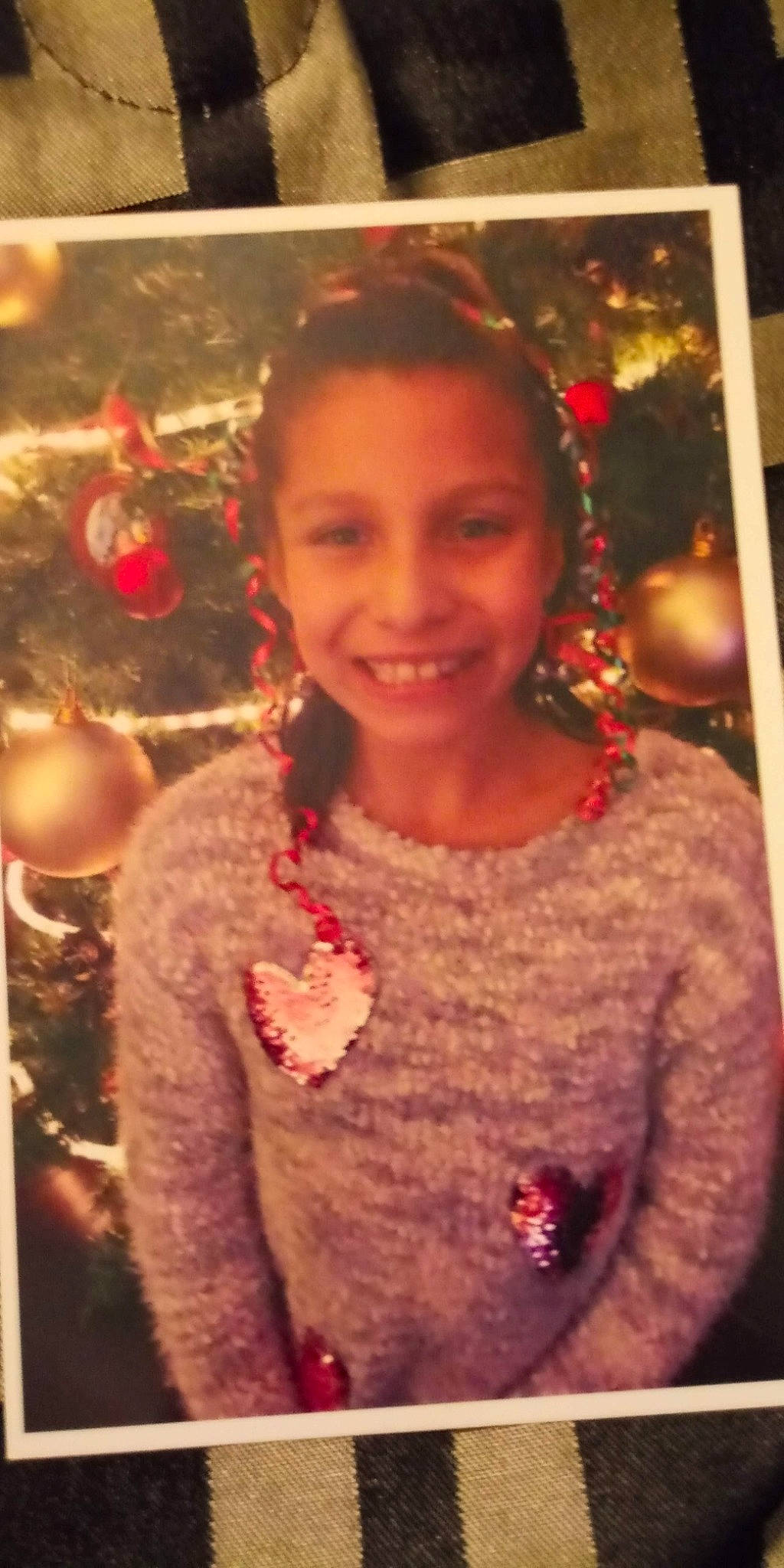 Angelica is registered to the contest to win money with this photo: brown_hair, christmas, cool, forehead, fun, hair, hairstyle, joy, long_hair, person, smile, sweater, top