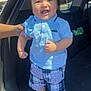 baby, child, toddler, smiling, blue_shirt, plaid_shorts, socks, car, car_trunk, hand, sunlight, outdoor, happy, clothing, person, cute, standing, portrait, daylight, human