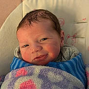 Jaxton is registered to the contest to win money with this photo: newborn, baby, blanket, cushion, face, infant, portrait, wrapped, cozy, cute, sleeping_baby, child, indoors, soft, warm, resting, smiling, young, person, baby_clothes